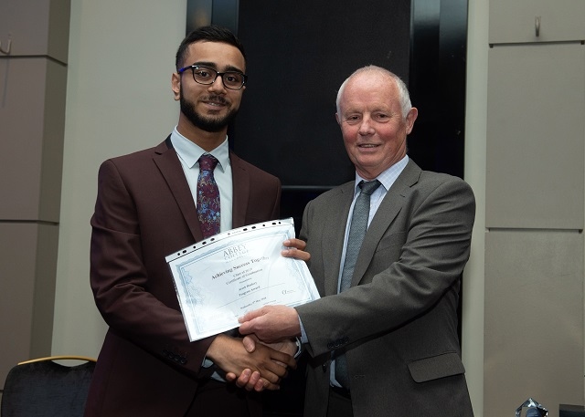 Areeb Haidery receiving a special award for progress presented by Bill Dwyer