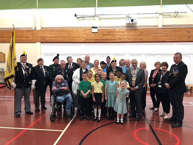 Former servicemen and servicewomen with pupils from Shawclough Community Primary School