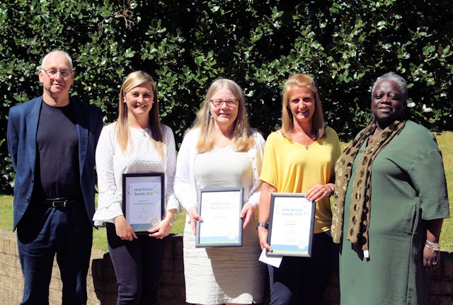 Daniel Benjamin (left), Non-Executive Director, and Evelyn Asante-Mensah OBE (right), presenting Long Service Awards to Pennine Care staff