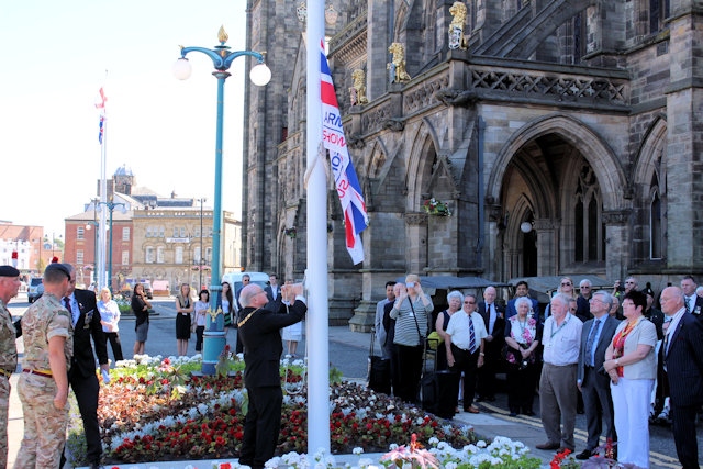 The Deputy Mayor of Rochdale, Councillor Billy Sheerin, raises the flag for Armed Forces Day