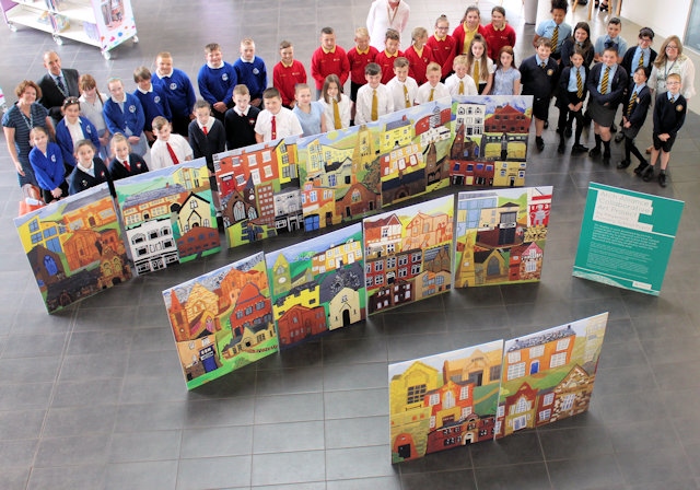 Pupils with their artwork on display, with Gail Hopper, Councillor Kieran Heakin and artist Collin Lyall 