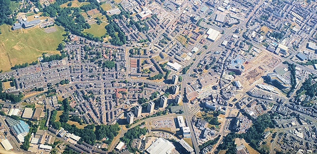 Aerial photograph of Rochdale town centre, right Number One Riverside and transport interchange, Smith Street, John Street, Molesworth Street top right and centre of the photo and St Mary's Gate with the town flats on the left. Top left is Falinge Park High School and playing fields. 
