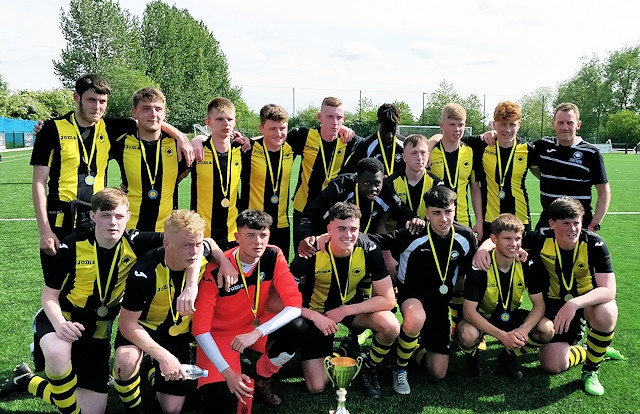 Hopwood Hall College's football team pose with the County Cup