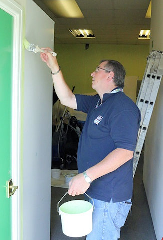 Employee representative David Bulcock painting at the Mind café in Middleton