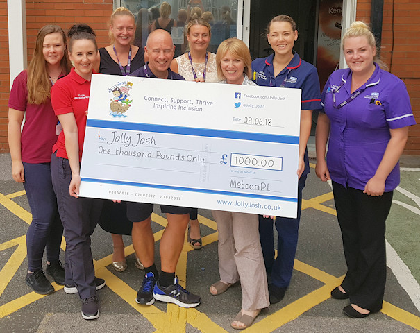 NHS staff with the £1,000 cheque for Jolly Josh