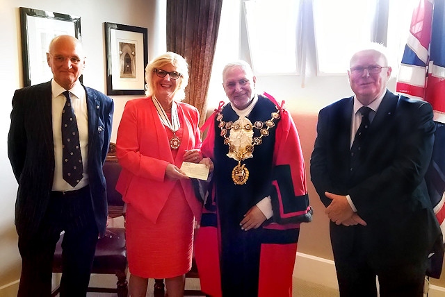 Vivien Carter presents the Mayor with a £500 cheque