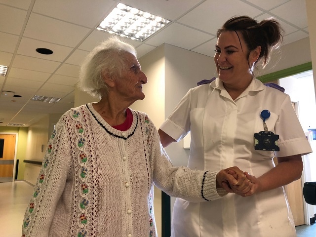 Lynette Cook, activities co-ordinator on Wolstenholme Unit, helping a patient