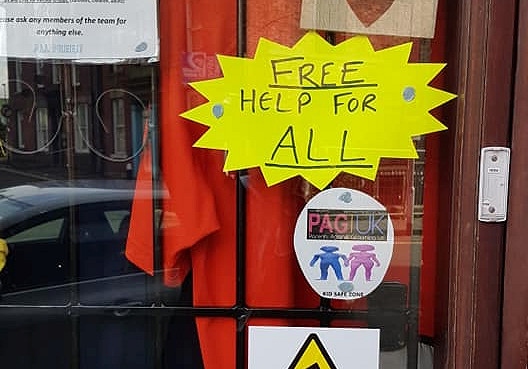 A Kid Safe Zone image displayed in the window of the Parents Against Grooming UK walk-in centre on Yorkshire Street, Rochdale