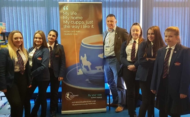 Owner of Bluebird Care John Keogh with students from Whitworth Community High School