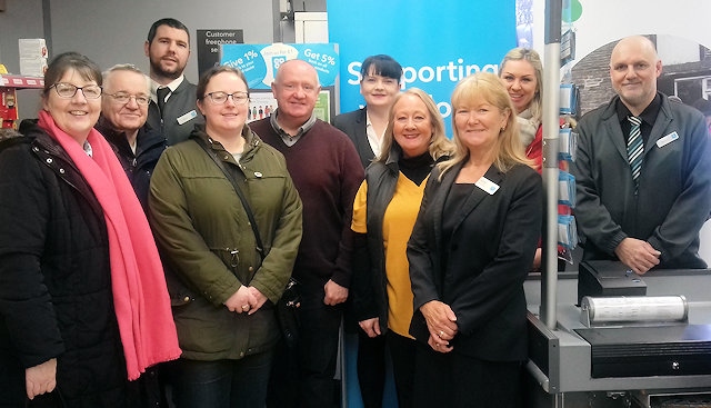 Bev Place, Co-op Member Pioneer (in yellow) with colleagues from the Cutgate Store, Rooley Moor Stores and Funeralcare with representatives from RED-AID; The Hebron Pentecostal Church and HMR Circle