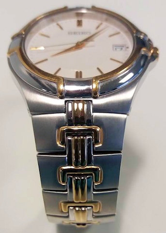 Silver-coloured Seiko bracelet wrist watch with gold features