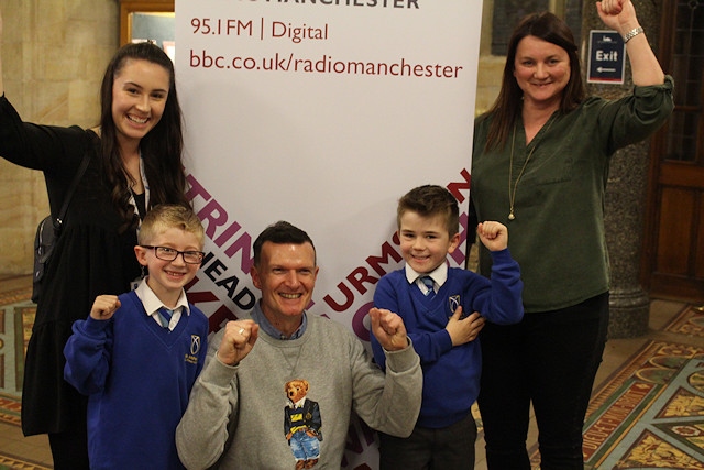 All smiles as the winners of the name the bells competition are announced: L-R: Miss Morris, year 2 teacher St Andrew's Primary School; Noah Spillane, year 2 pupil St Andrew's Primary School; Phil Trow, BBC Radio Manchester presenter; Harry Ostafijczuk, year 2 pupil St Andrew's Primary School; Louise Taberner, who was one of the competition winners. 