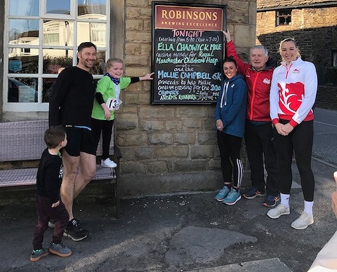 Ella Chadwick (third left) and Mollie Campbell (far right) with race organiser Andy O'Sullivan (second right) with runner Helen Smith (third right) and Will Smith (second left)