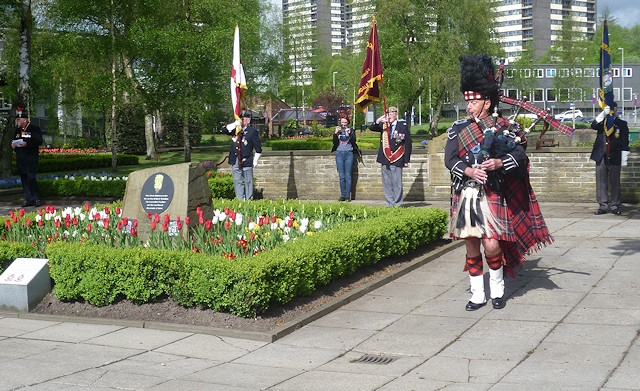 A bagpiper opened the service