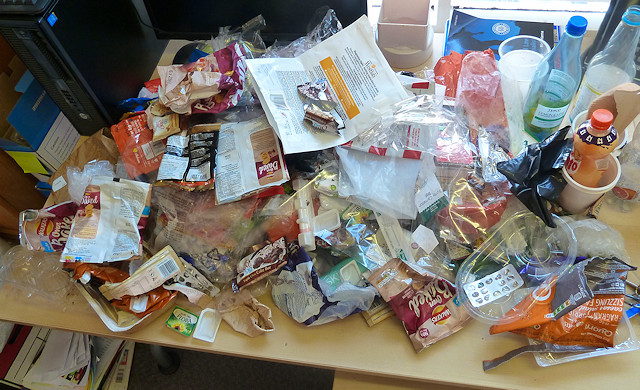 A months' worth of plastic packaging covering a desk