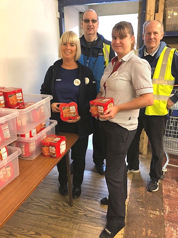 Rochdale Foodbank volunteers (back) with Tesco staff Angela Gilbertson (left), community champion, and Toni Wilson (right), grocery manager