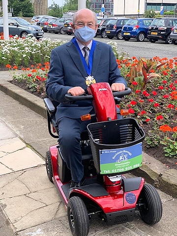 Mayor Billy Sheerin on one of the four new Rochdale Mobility scooters