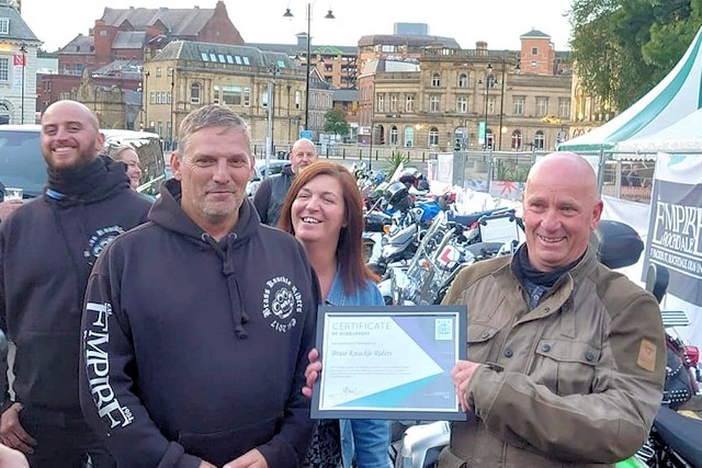 Members of Brass Knuckle Riders with their certificate from the mayor