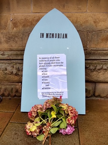 The tombstone and flowers from Extinction Rebellion Rochdale outside Barclays bank, Rochdale