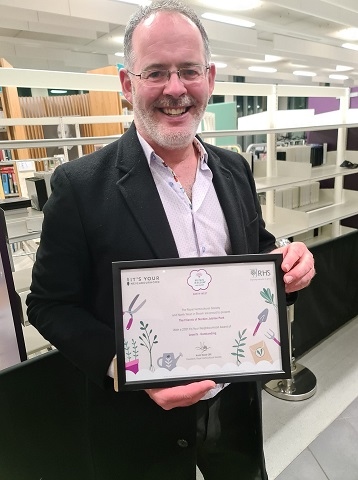 Volunteer Phil Starr with the award for Norden Jubilee Park