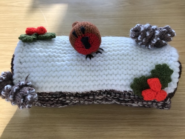 Get crafty and make some homemade decorations instead (pictured: a knitted robin sits on a knitted log)