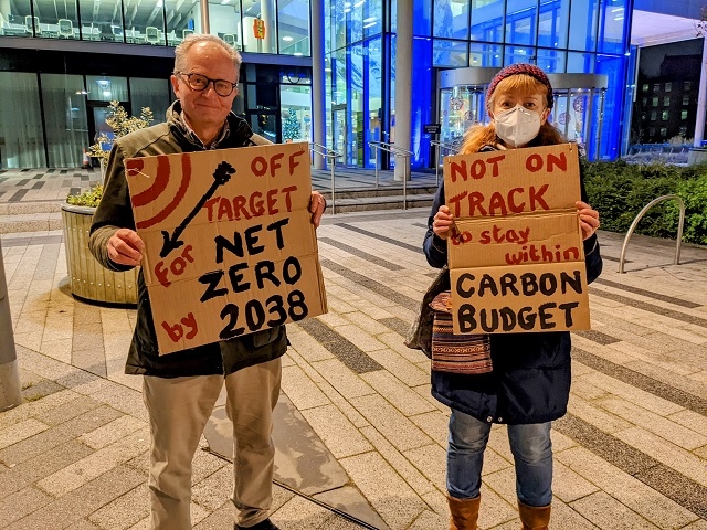 Reverend Mark Coleman and Jane Touil, Extinction Rebellion Rochdale, outside Number One Riverside with their placards