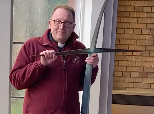 Reverend Philip Miller with the cross which fell from the church roof