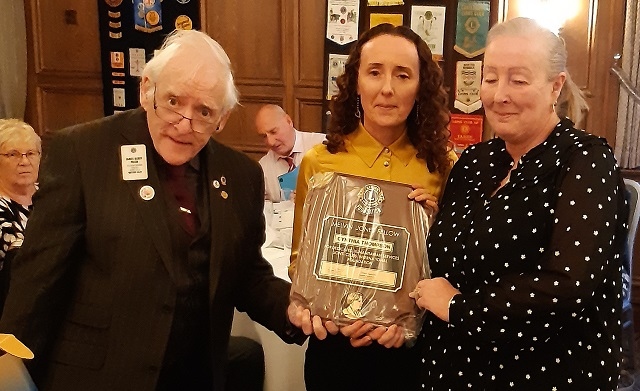 Immediate past district governor Lion Barry Prior presents the Fellowship to the late Cynthia Thompson's daughters, Lisa Groome and Janice Colquhoun