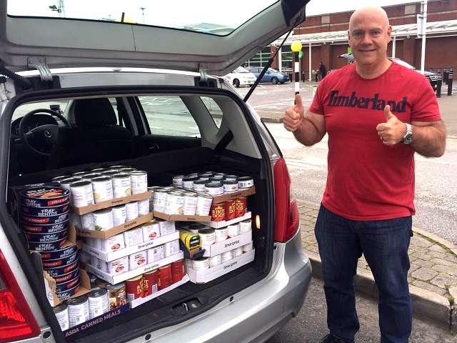 Rochdale Freemasons district charity steward John Taylor with a car full of tins for the foodbank