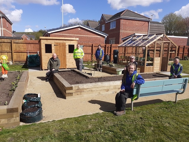 Residents and Green Team members enjoy the finished garden.