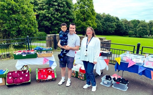 Families making use of the high quality uniform on offer, with Councillor Rachel Massey