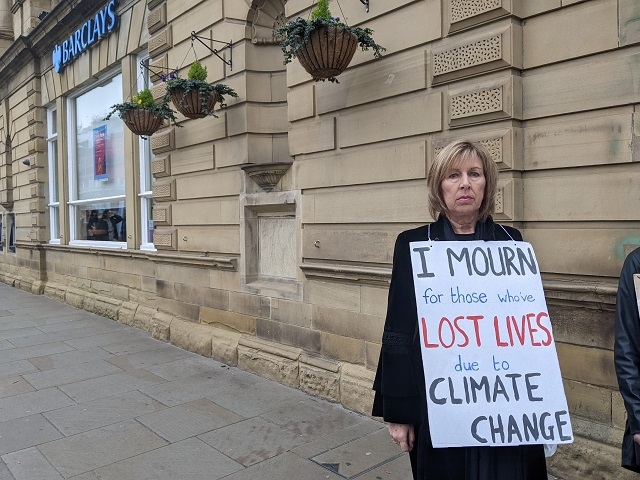 Extinction Rebellion activists held a mock funeral procession at Barclays bank, Rochdale