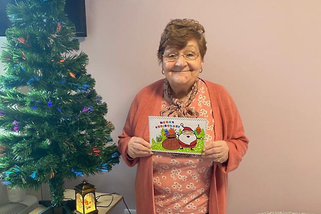 Janice with the Christmas card she received