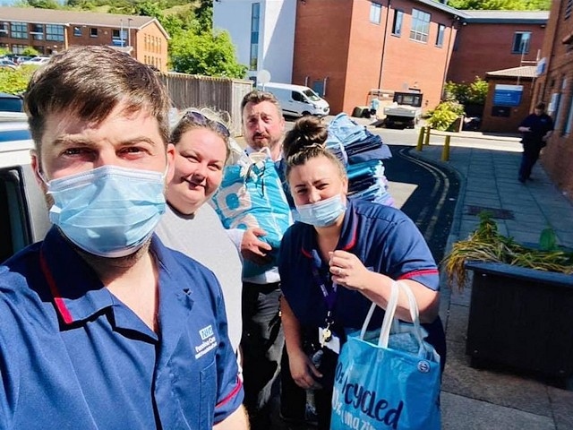 Zoe (second left) delivering scrubs to medical staff