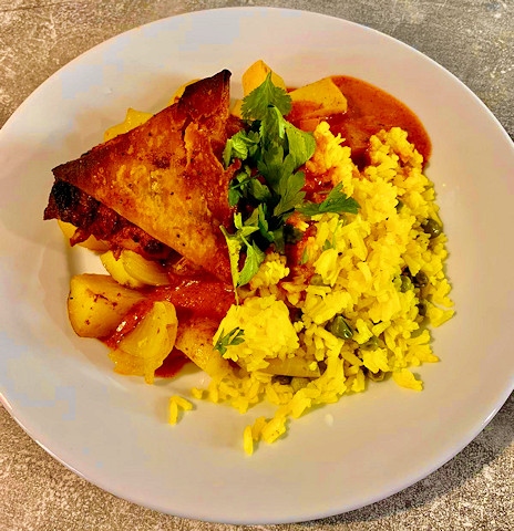 Chicken curry with saffron rice pilaf, Bombay potatoes and a samosa