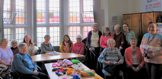 Group members at Heywood Library (right) – Jane Ashworth, education lead at Springhill Hospice with one of the bears made by the group