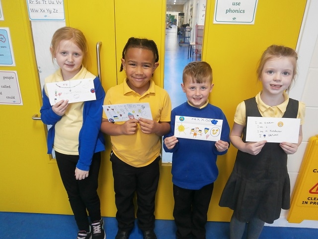 Hollins Primary pupils with some of their letters to Ukraine 