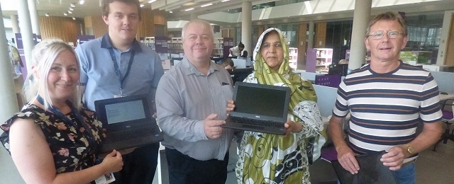 Council leader Neil Emmott (centre) at a digitech library session, with residents and council staff