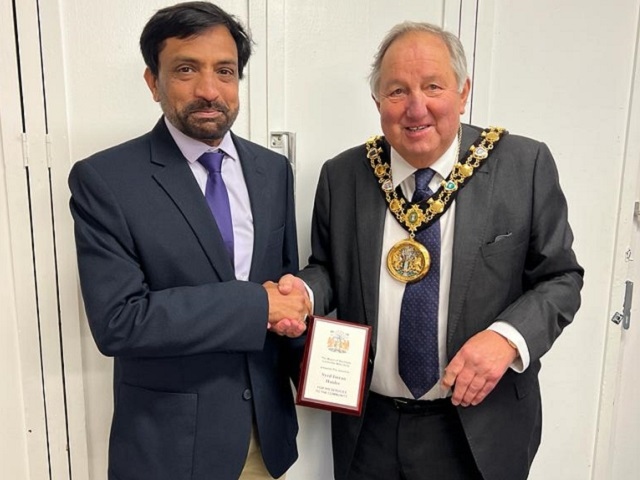 Mike Holly, the Mayor of Rochdale, presents a shield to Syed Imran Haider, outgoing NADRA manager of the Pakistan Consulate in Manchester