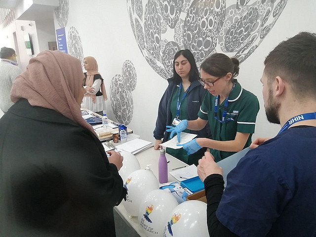 Clinical Research Practitioner Caroline Winckley explains the Genes and Health Study to a participant in Rochdale Leisure Centre