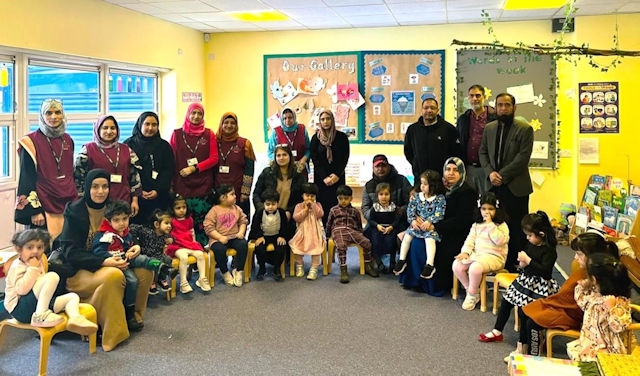 Deeplish Community Centre’s Sunshine Preschool team with parents and children 