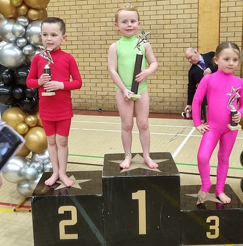 Mia-Grace Walsh, centre, with one of her trophies