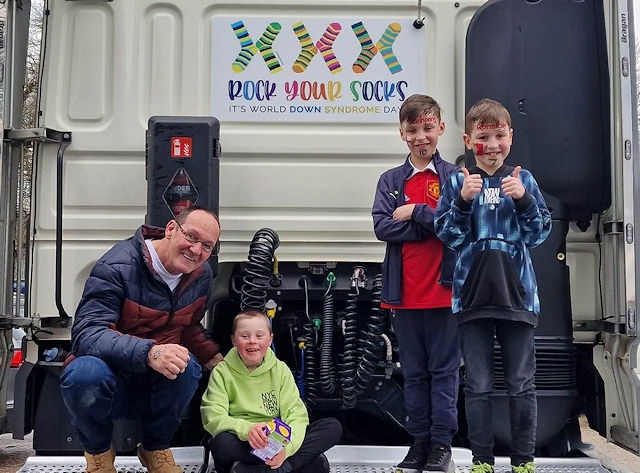 Brandon with his brothers Bradley and Jaxxon and grandad Steven on the back of the cab