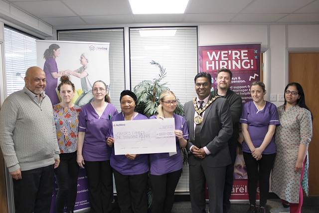 Members of the Community Careline Services presented Mayor Ali Ahmed with cheque for £1,000