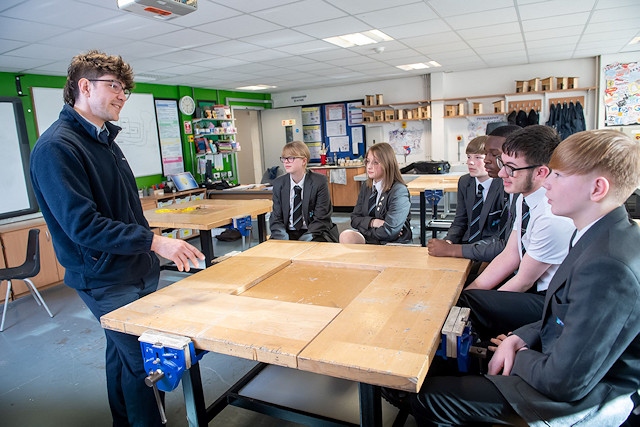 Sam Ward, assistant site manager for Bellway Manchester, gives a presentation about The Future Home to students at Newhouse Academy in Heywood