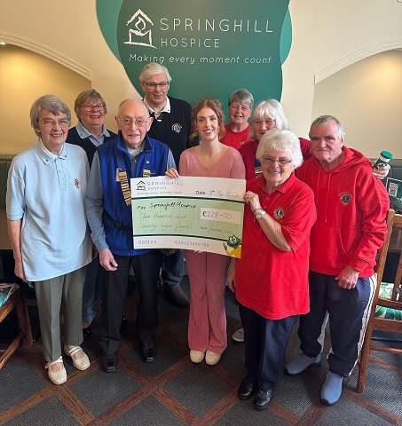 Heywood Lions president John Sagar with members of Heywood and Rochdale Lions Clubs presenting Springhill Hospice with a cheque