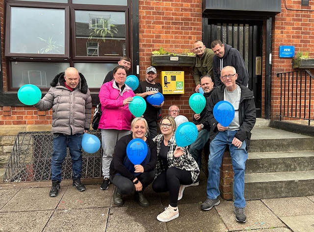 Staff and tenants with the new defibrillator