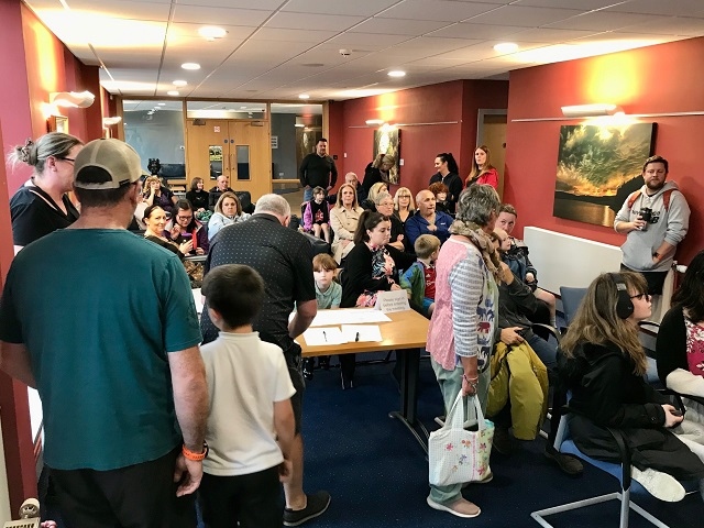 Residents in a reception area gather to hear questions on Whitworth Leisure Centre at Rossendale Council