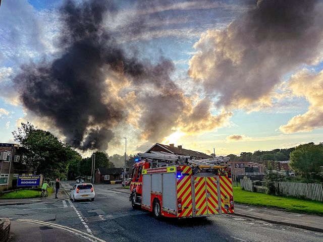 The fire involves a number of cars and a brick storage unit in a scrapyard