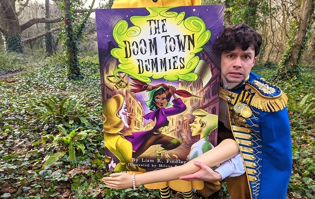 Liam Findlay promotional image with his book cover, The Doom Town Dummies